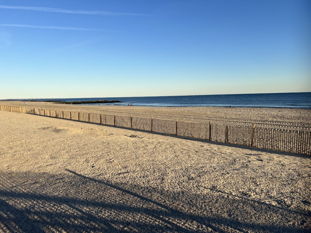 a sandy beach with a fence (MyCoast AI)