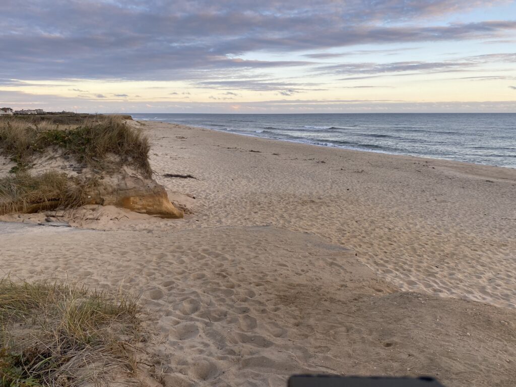 a sandy beach with water and clouds (MyCoast AI)