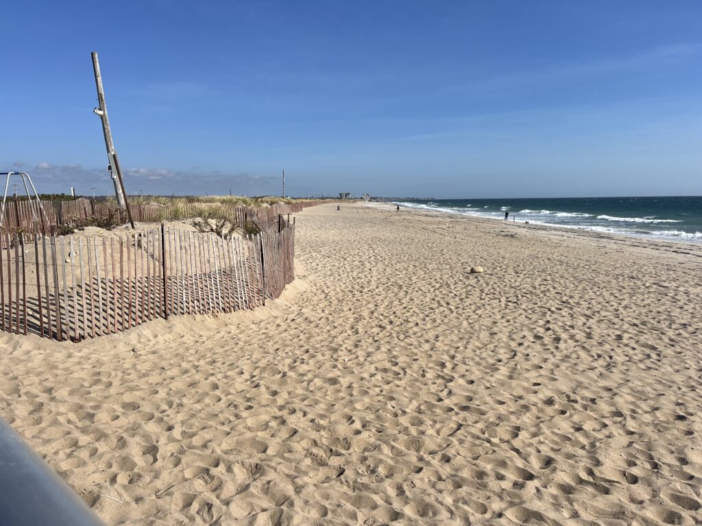 a sandy beach with a fence (MyCoast AI)