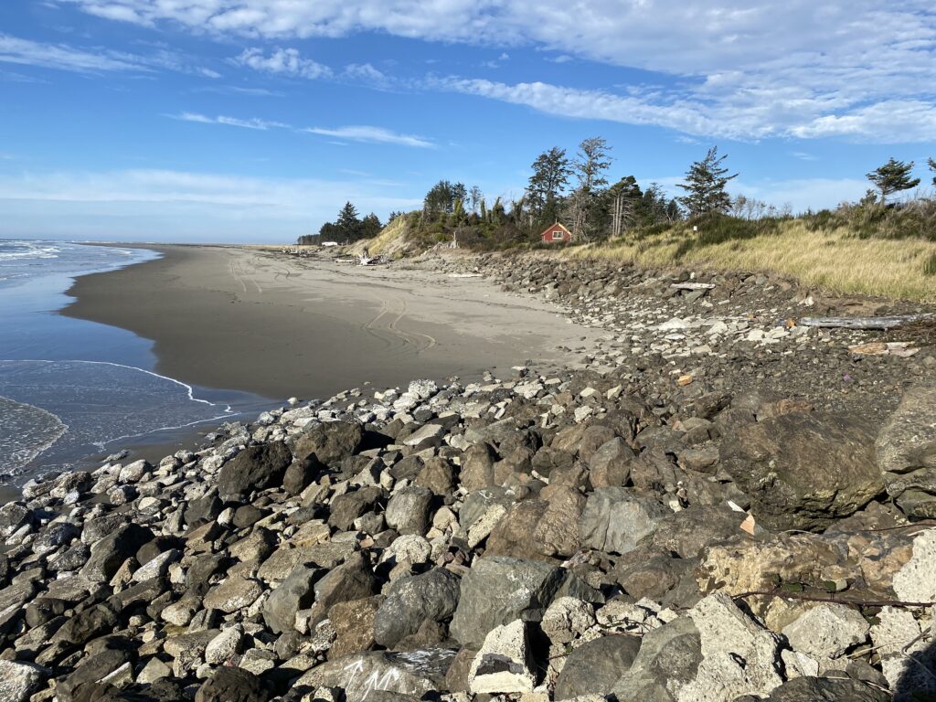 a rocky beach with a small house (MyCoast AI)