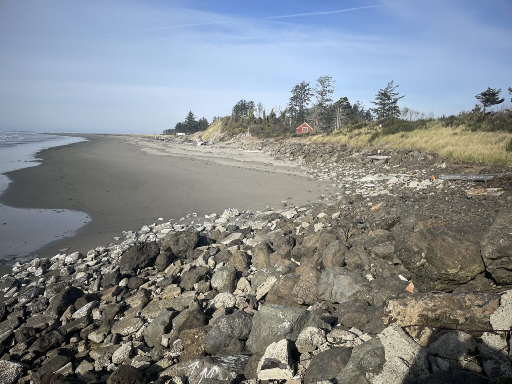 a rocky beach with a red house (MyCoast AI)