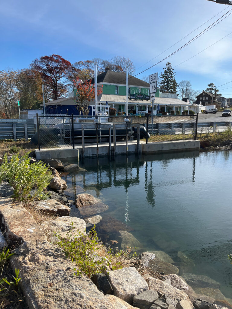 a body of water with a bridge and buildings in the background (MyCoast AI)