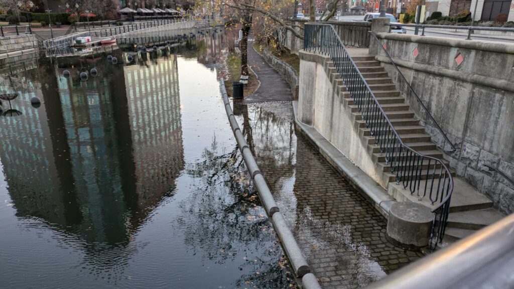 a canal with a stone wall and a stone walkway (MyCoast AI)