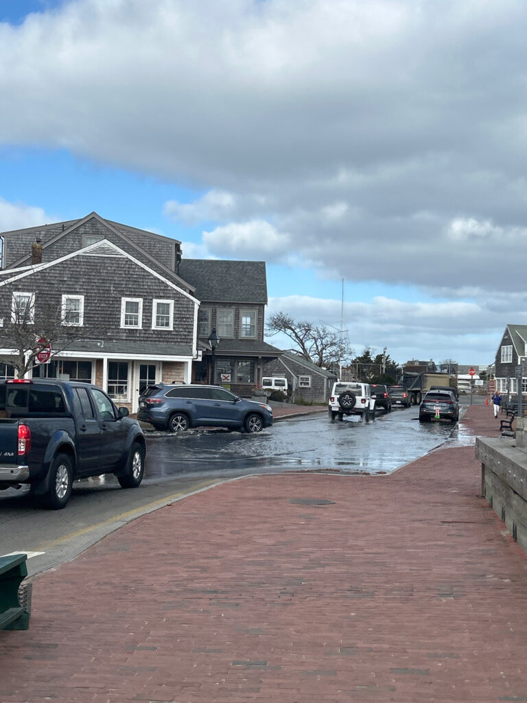 a group of cars parked on a street next to a row of houses (MyCoast AI)