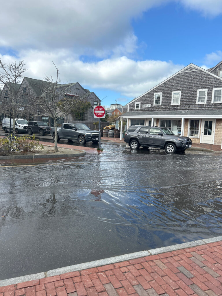 a flooded street with cars parked on the side (MyCoast AI)