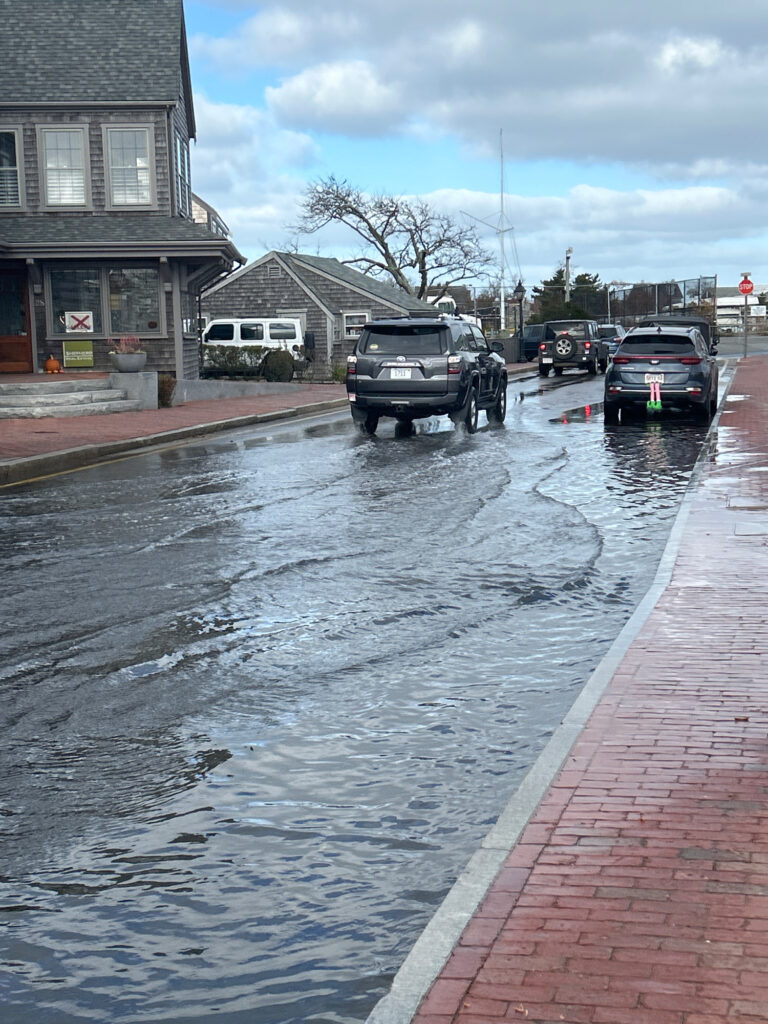 a flooded street with cars parked on the side (MyCoast AI)
