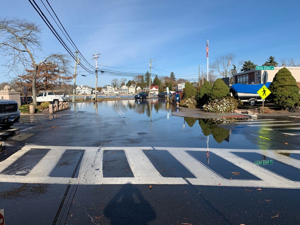 a flooded street with a truck and a car driving by (MyCoast AI)