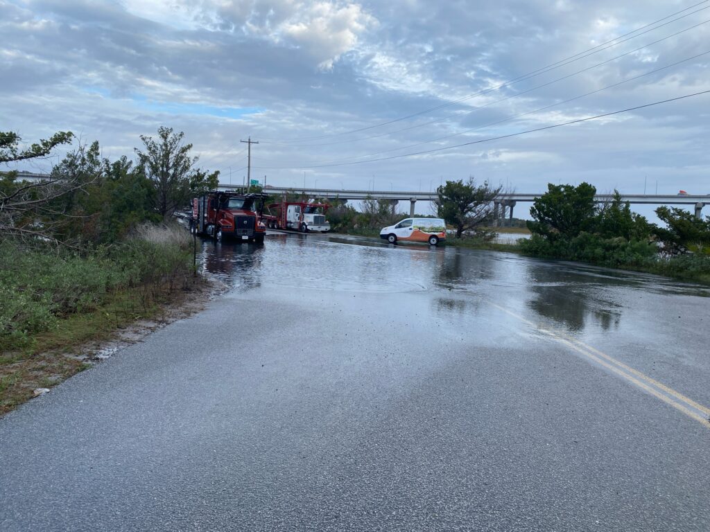 a flooded road with cars and trucks (MyCoast AI)