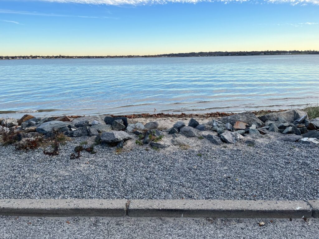 a rocky beach with water and blue sky (MyCoast AI)