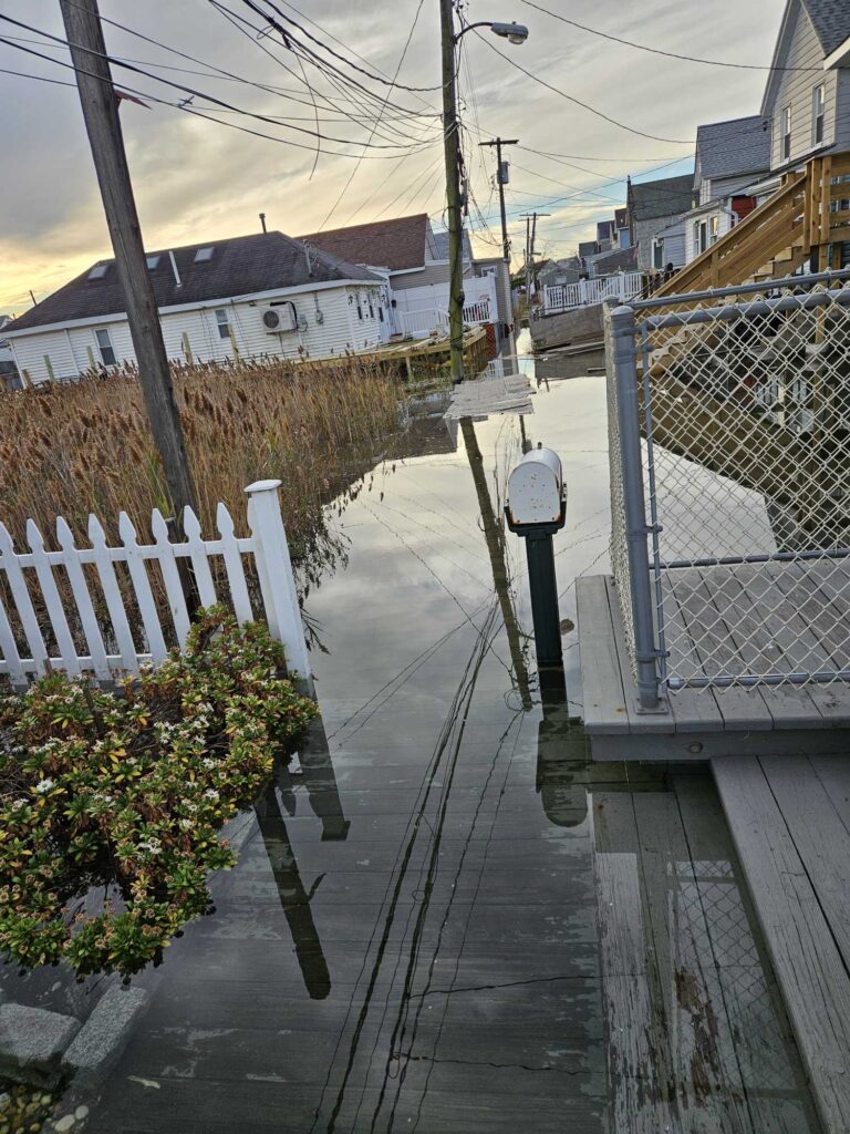 a sidewalk with a fence and a clock on it (MyCoast AI)