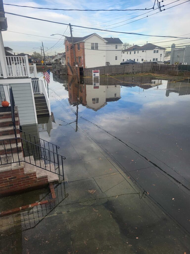 a flooded street with buildings on either side of it (MyCoast AI)