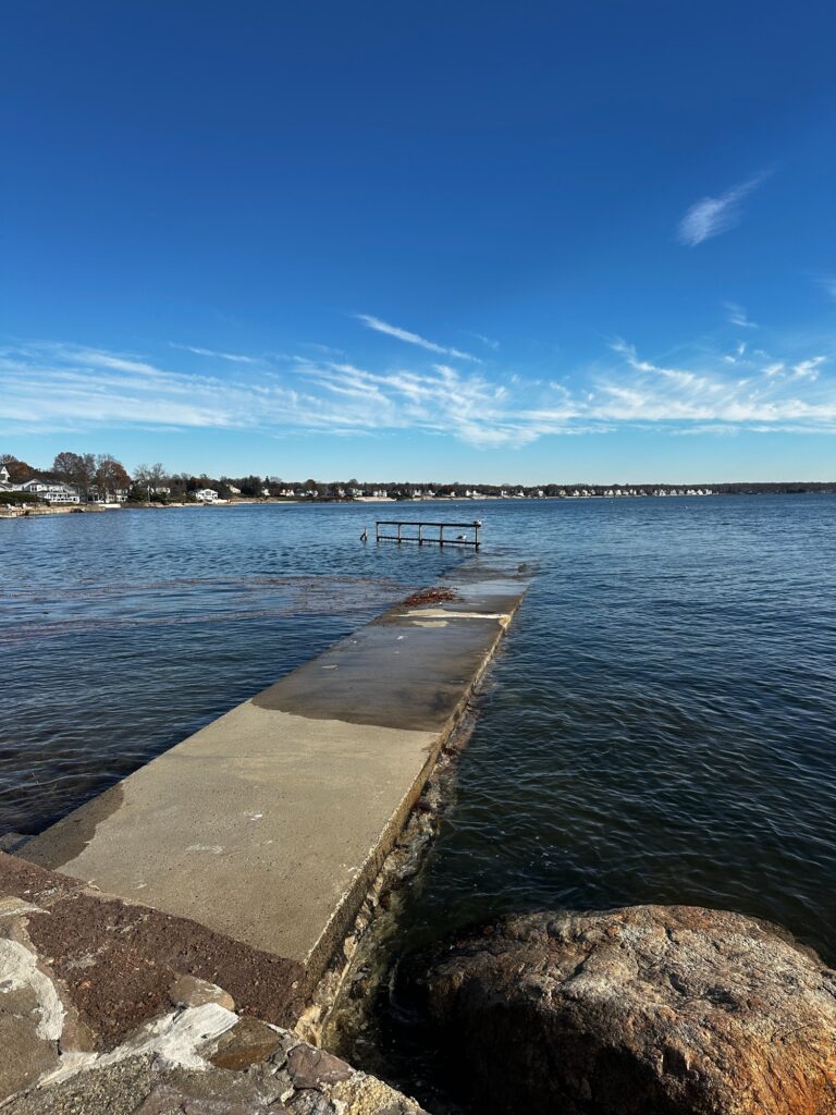 a body of water with rocks and a dock in it (MyCoast AI)