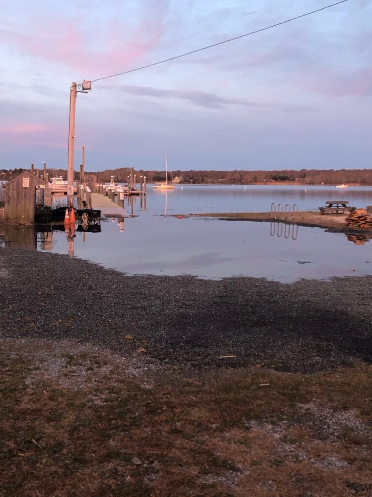 a body of water with a boat in it and a building in the back (MyCoast AI)