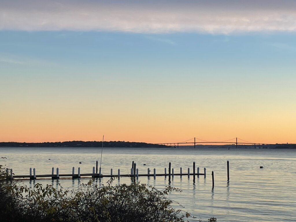 a body of water with a dock and a sunset (MyCoast AI)