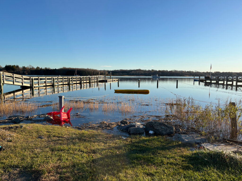 a body of water with a dock and a red object in it (MyCoast AI)