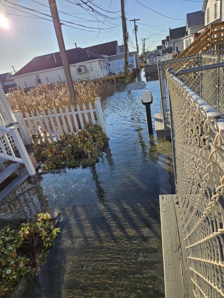 a canal with a white fence and a white picket fence (MyCoast AI)