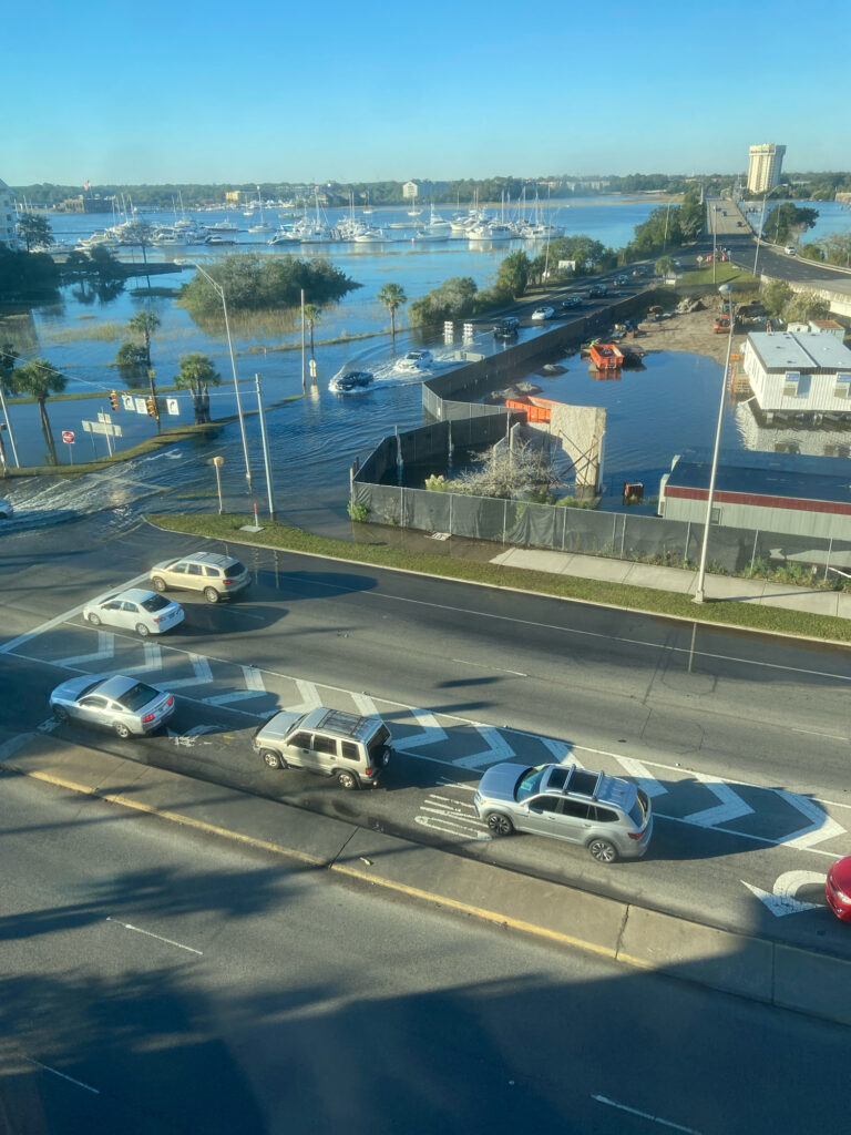 a parking lot with cars and a body of water in the background (MyCoast AI)