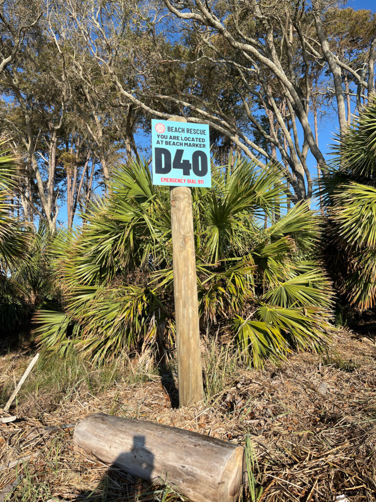 a sign in front of a tree (MyCoast AI)