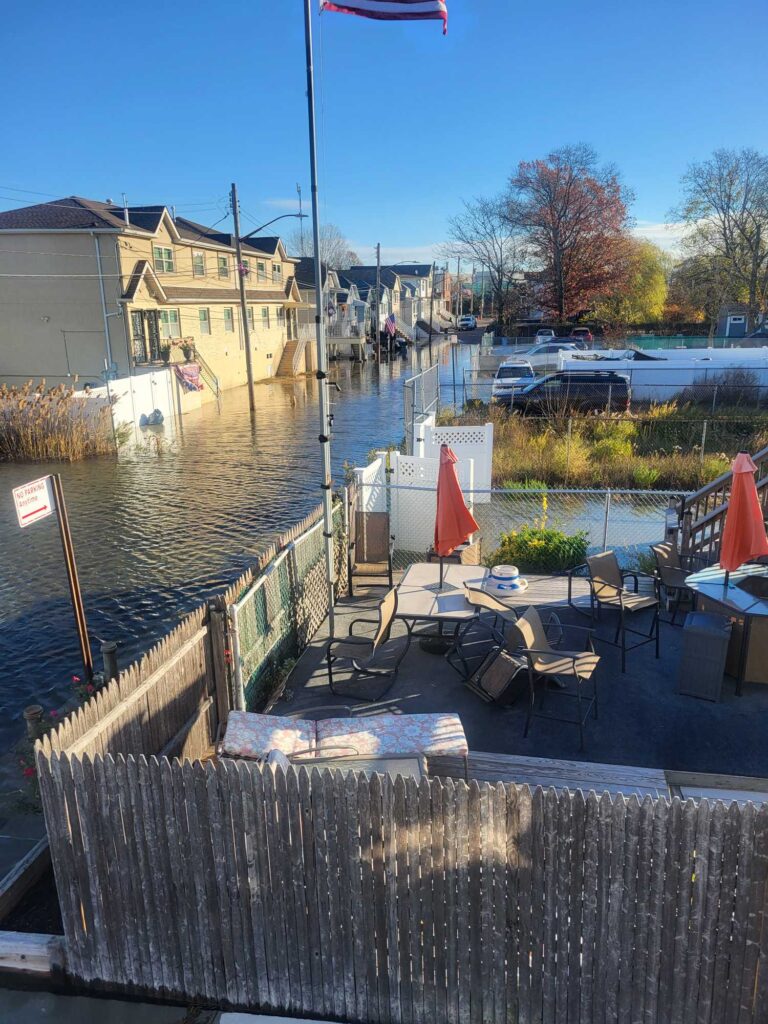 a deck with chairs and tables on it by a body of water (MyCoast AI)
