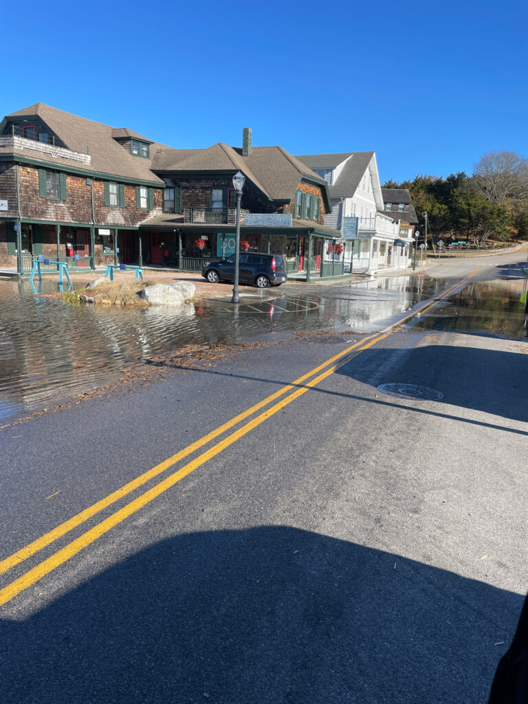 a car driving on a road next to a row of houses (MyCoast AI)