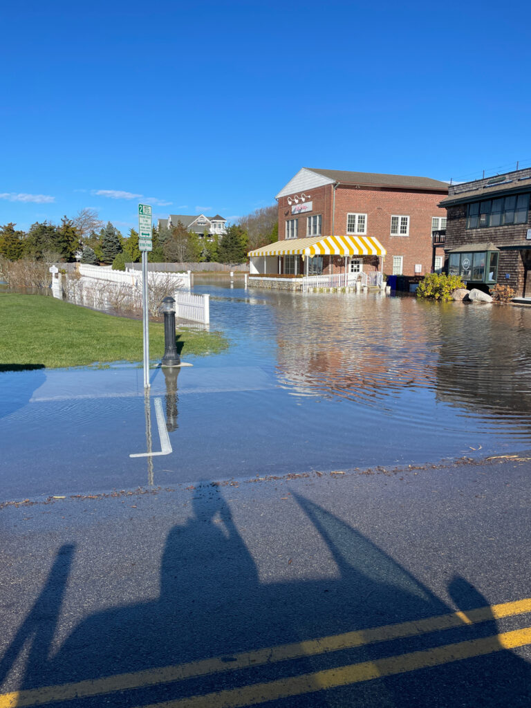 a flooded street with a building and a covered area (MyCoast AI)