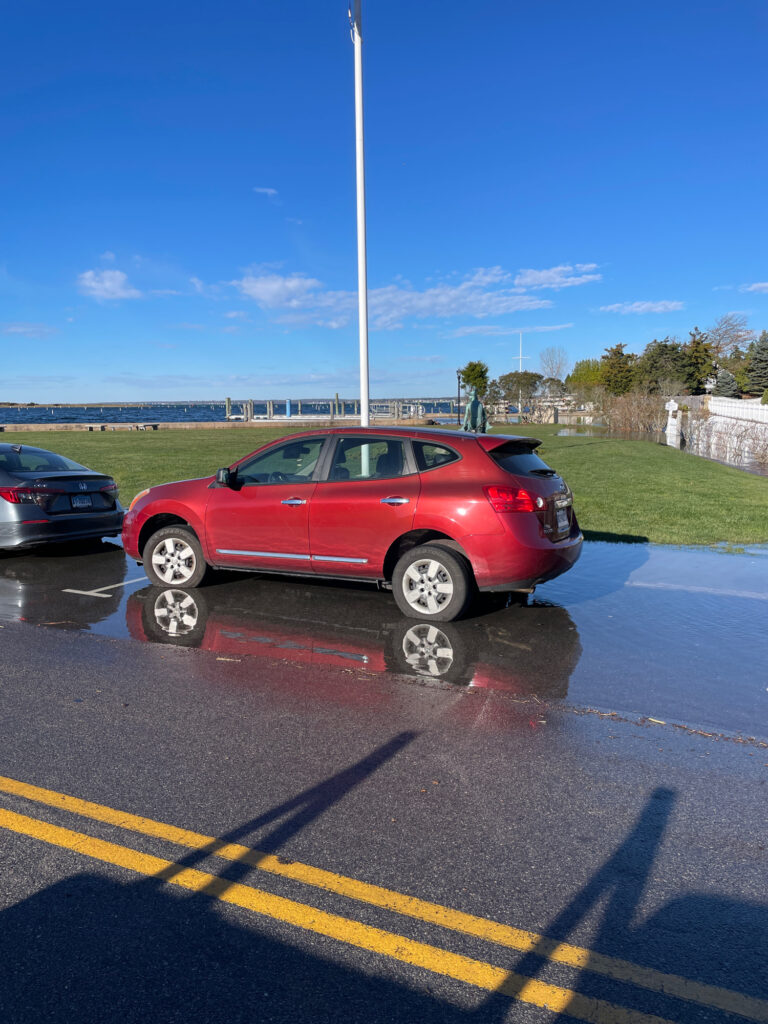 a red car parked in a parking lot (MyCoast AI)