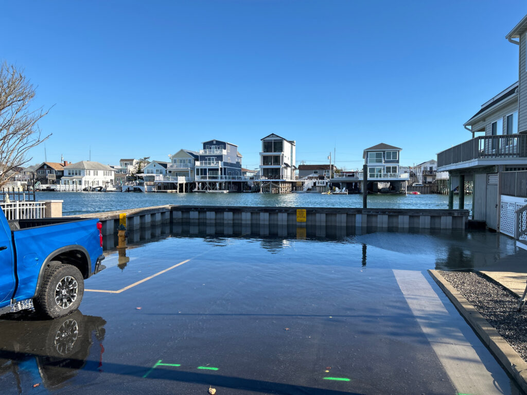 a truck parked next to a body of water with buildings in the background (MyCoast AI)