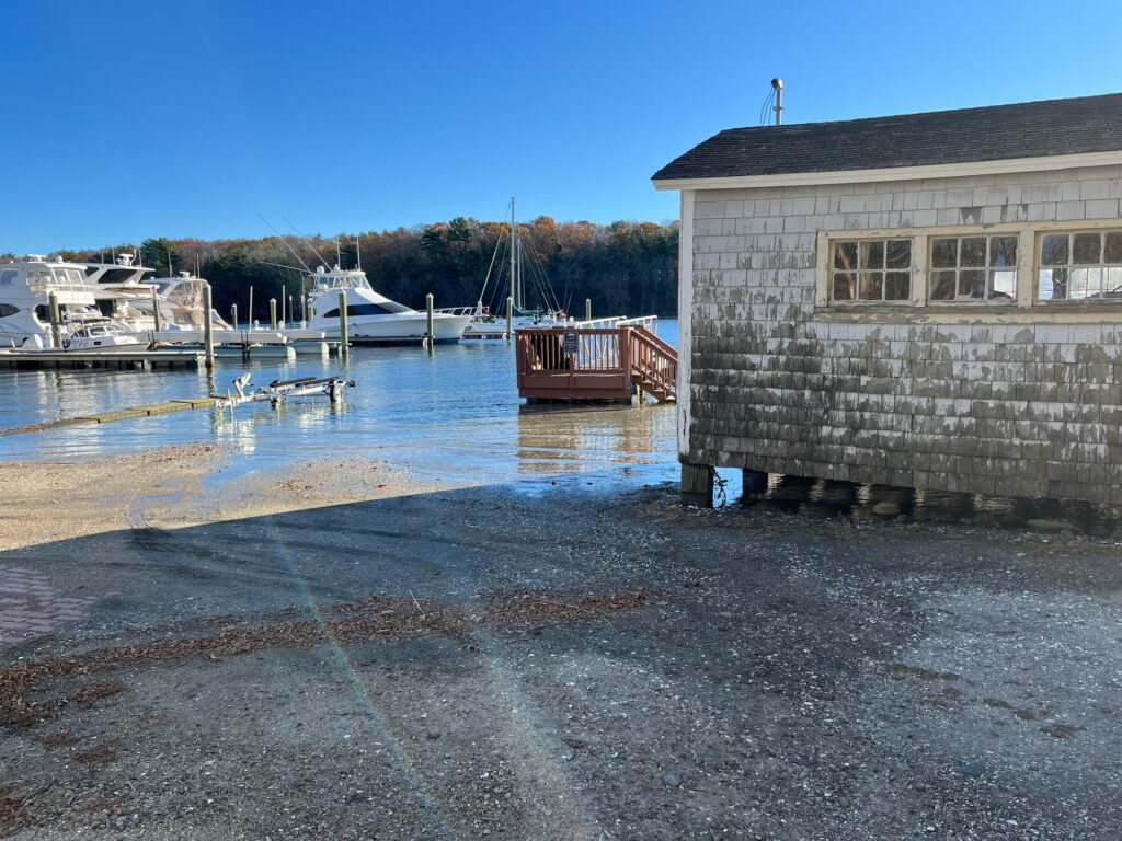 a building next to a body of water with boats in it (MyCoast AI)