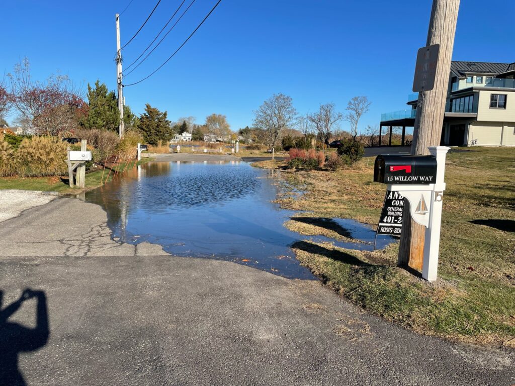 a flooded street with a sign (MyCoast AI)