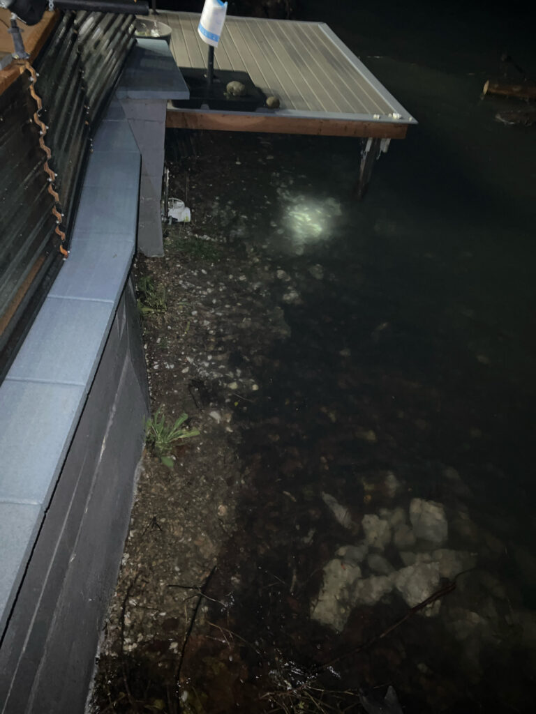 a small pond with a wooden bridge (MyCoast AI)