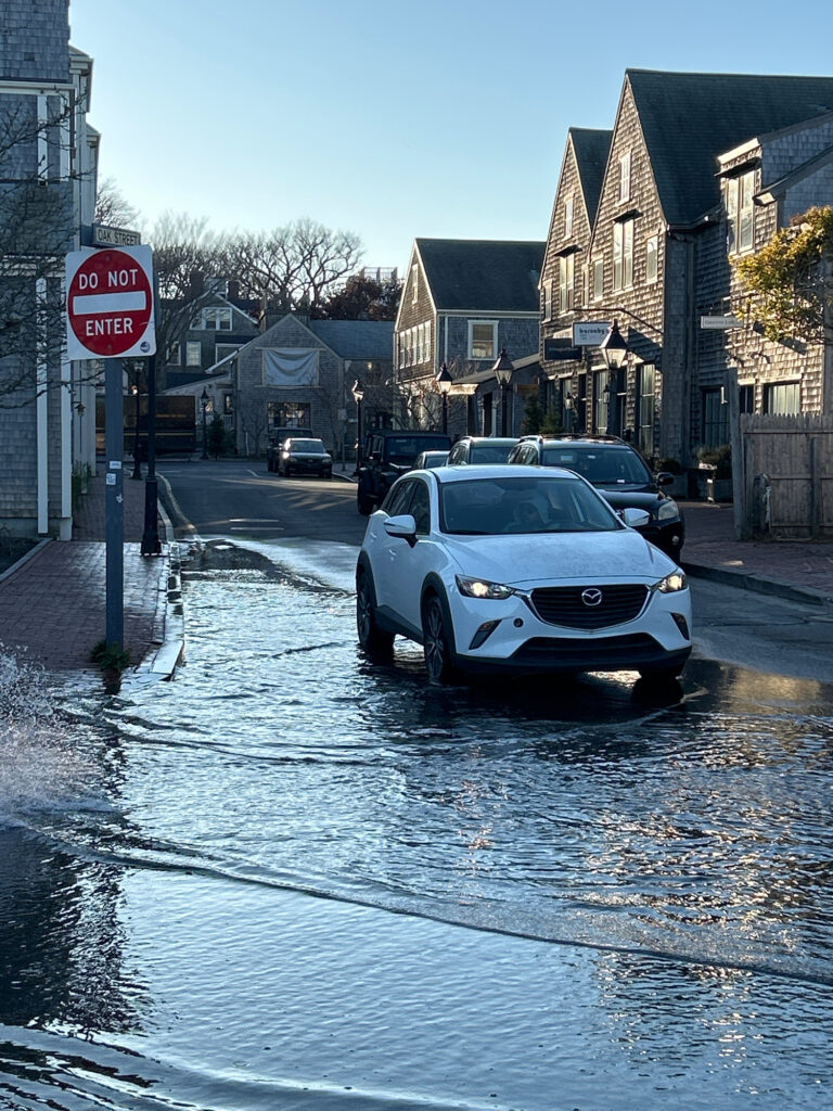 a white car driving through a flooded street (MyCoast AI)