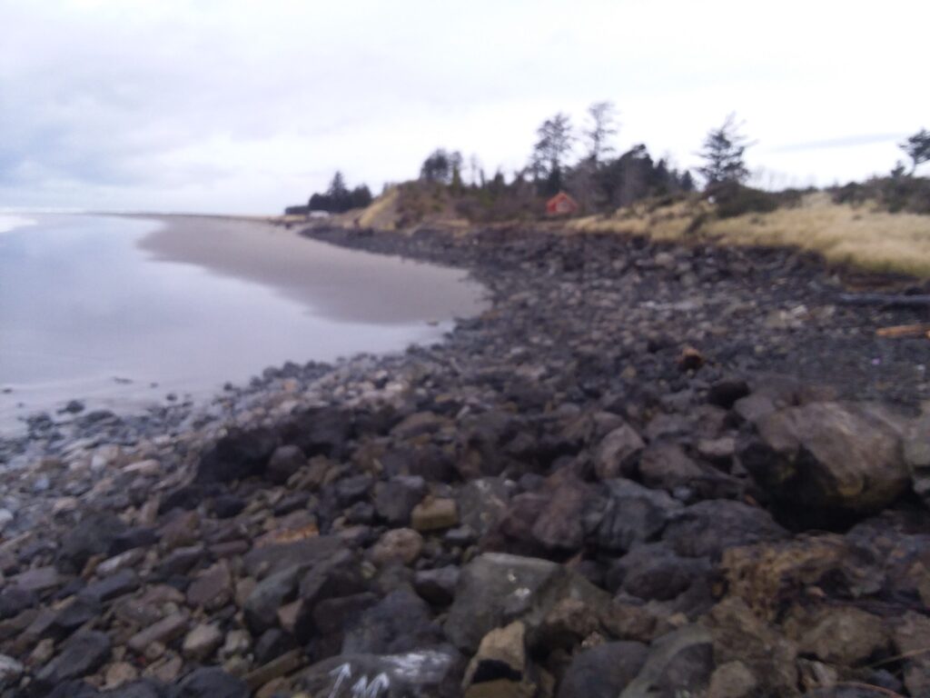 a rocky beach with a small house (MyCoast AI)