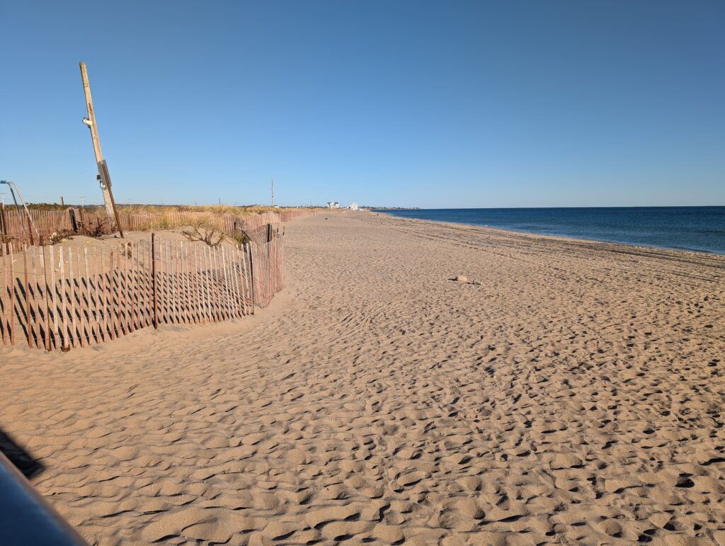 a sandy beach with a fence (MyCoast AI)