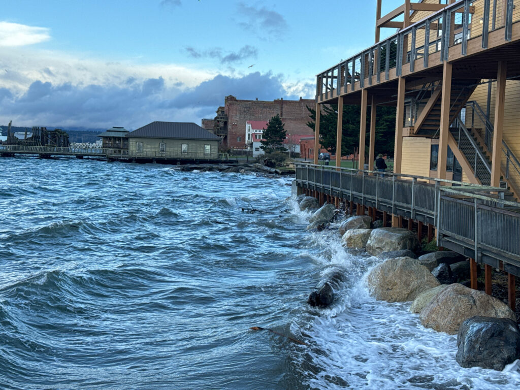 a body of water with rocks and buildings along it (MyCoast AI)