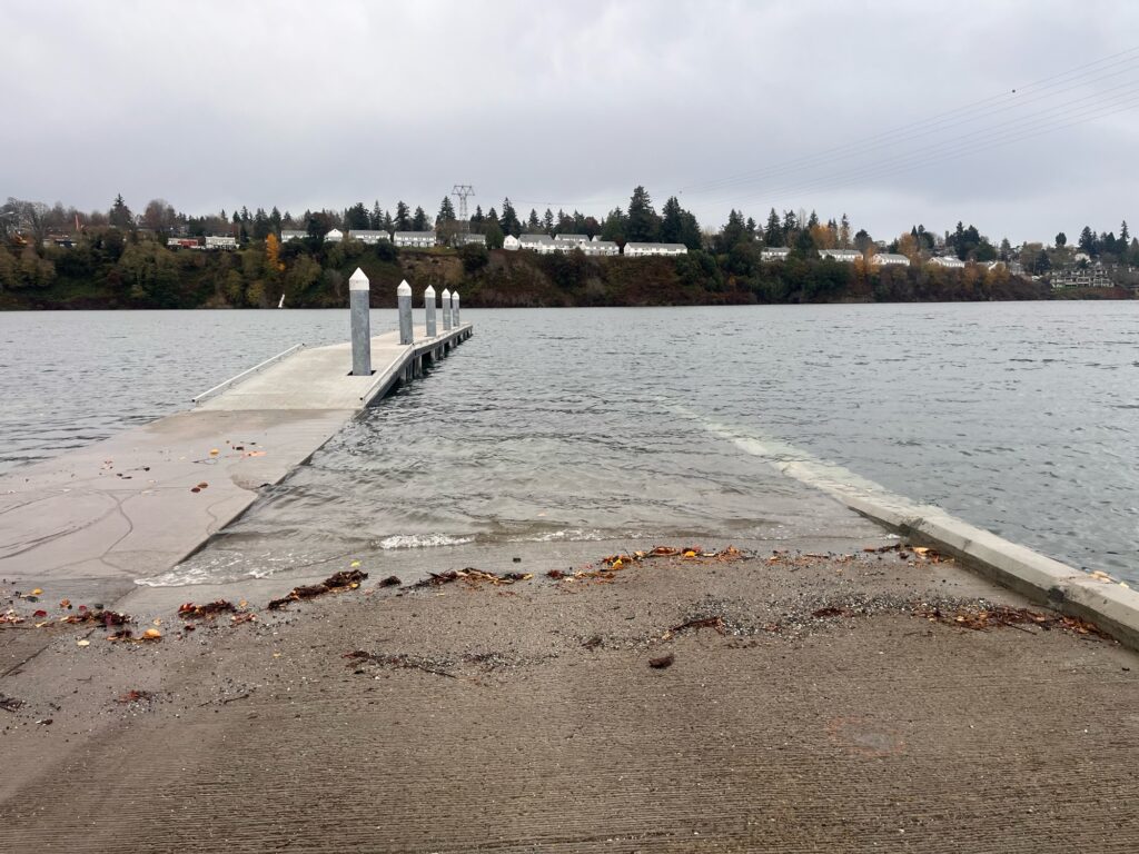 a body of water with a concrete walkway and a concrete wall (MyCoast AI)