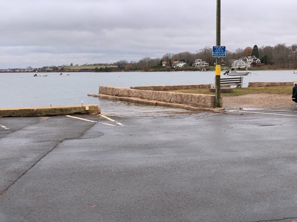 a road with a sign on it by a body of water (MyCoast AI)