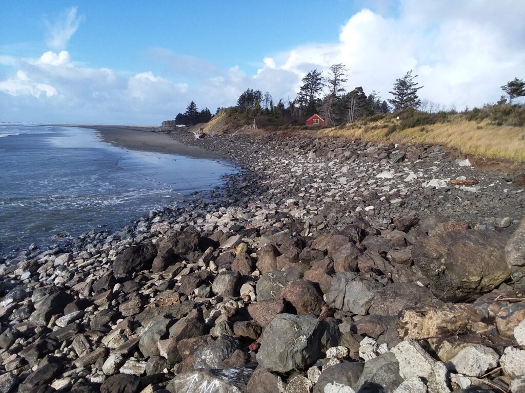 a rocky beach with a red house (MyCoast AI)