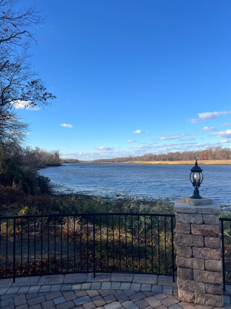 a stone walkway next to a body of water (MyCoast AI)