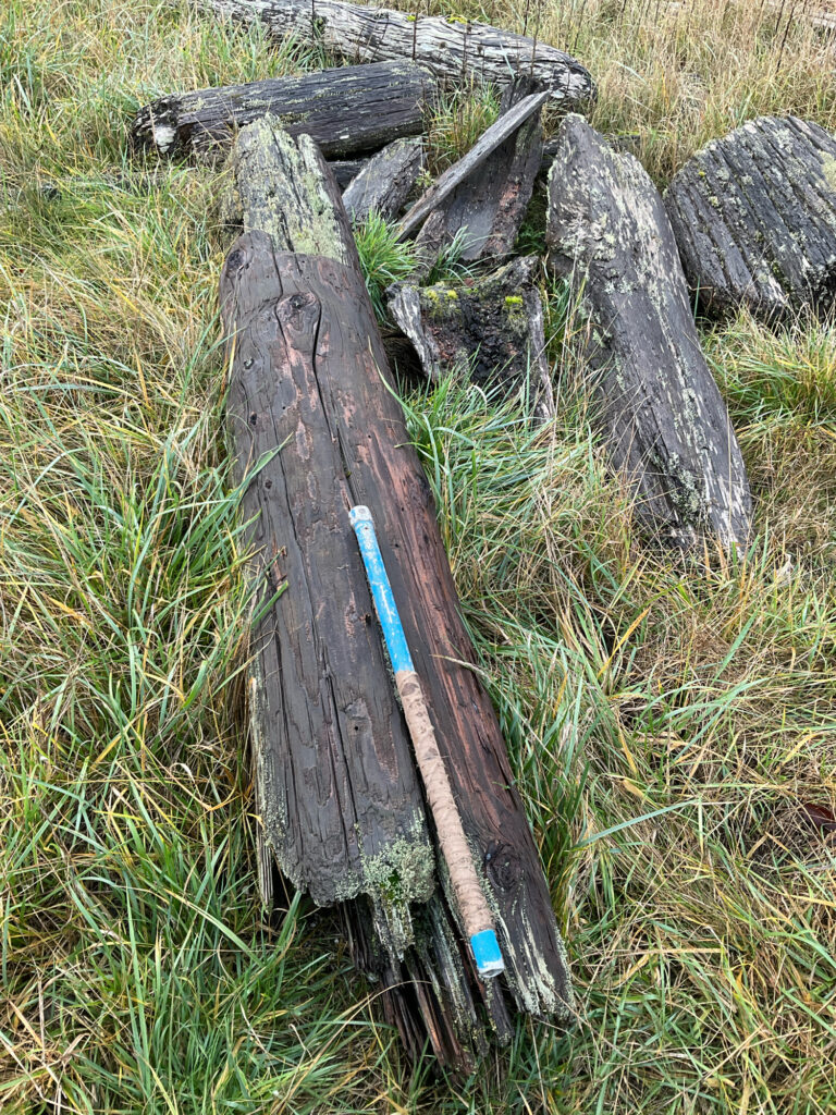 a wooden cross on a log (MyCoast AI)