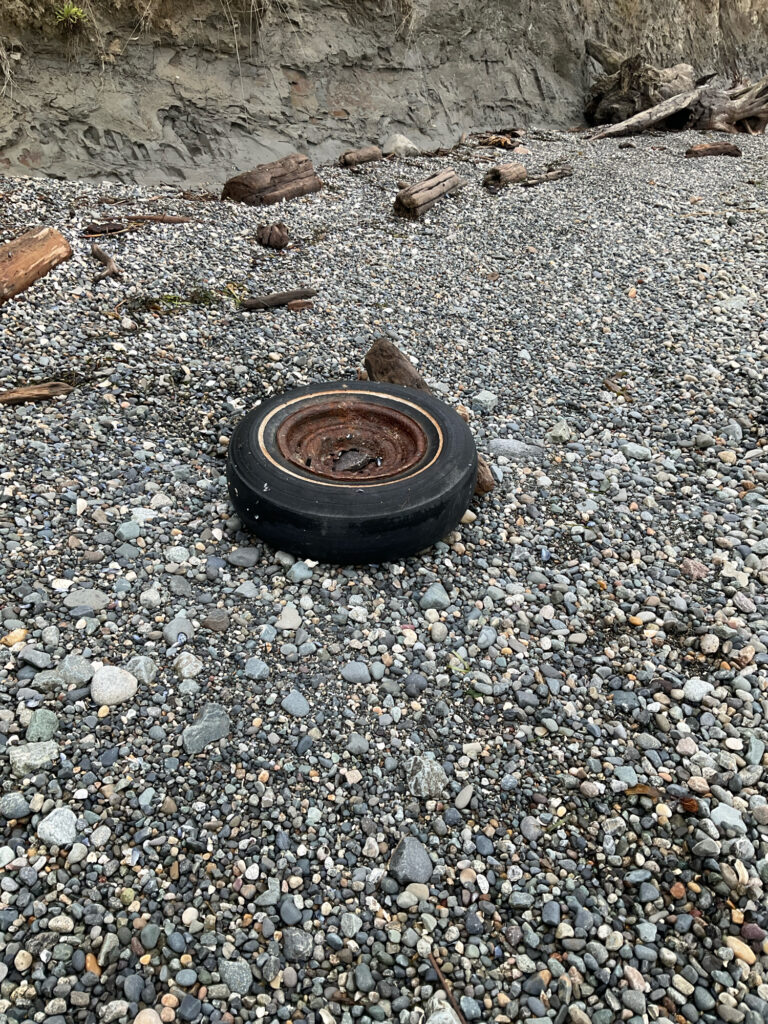 a black tire on gravel (MyCoast AI)
