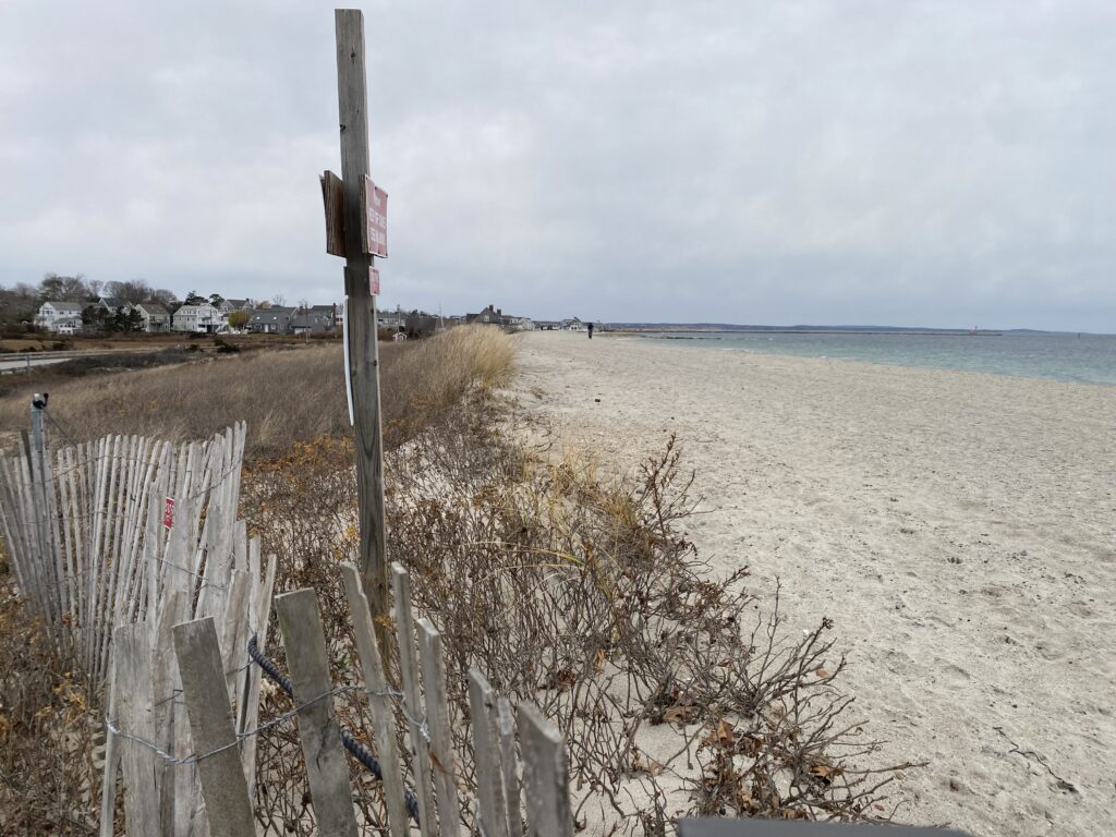 a beach with a fence and a sign (MyCoast AI)