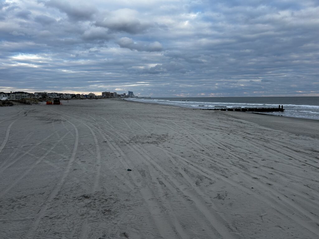 a sandy beach with waves crashing on it (MyCoast AI)