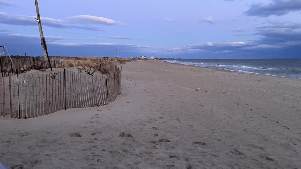 a sandy beach with a fence (MyCoast AI)