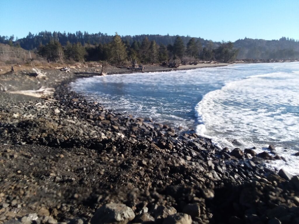 a rocky beach with waves crashing (MyCoast AI)