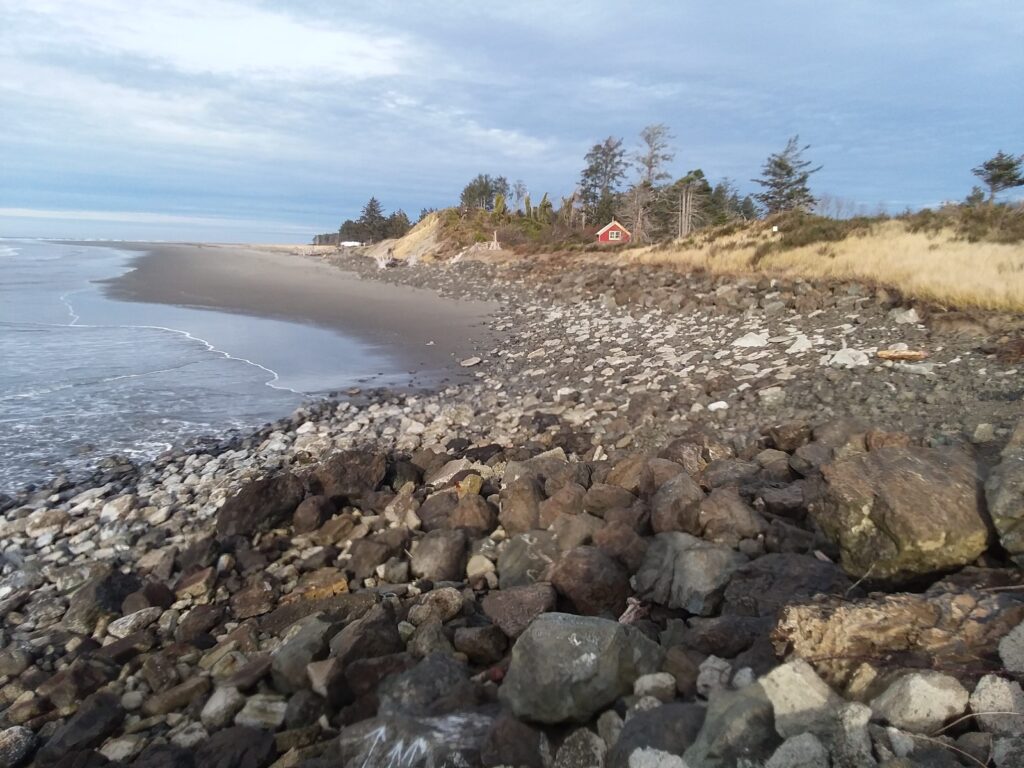 a rocky beach with a red house (MyCoast AI)