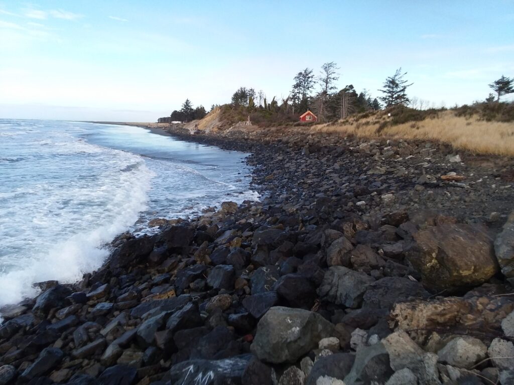 a rocky beach with a red tent (MyCoast AI)