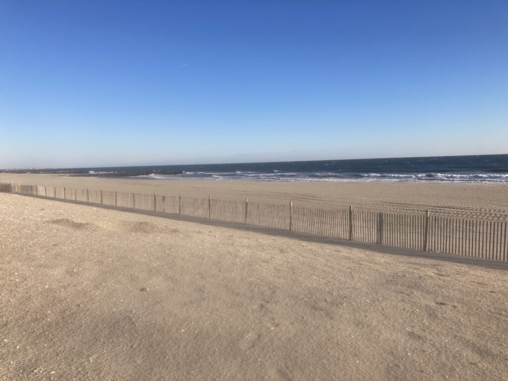 a sandy beach with a fence (MyCoast AI)