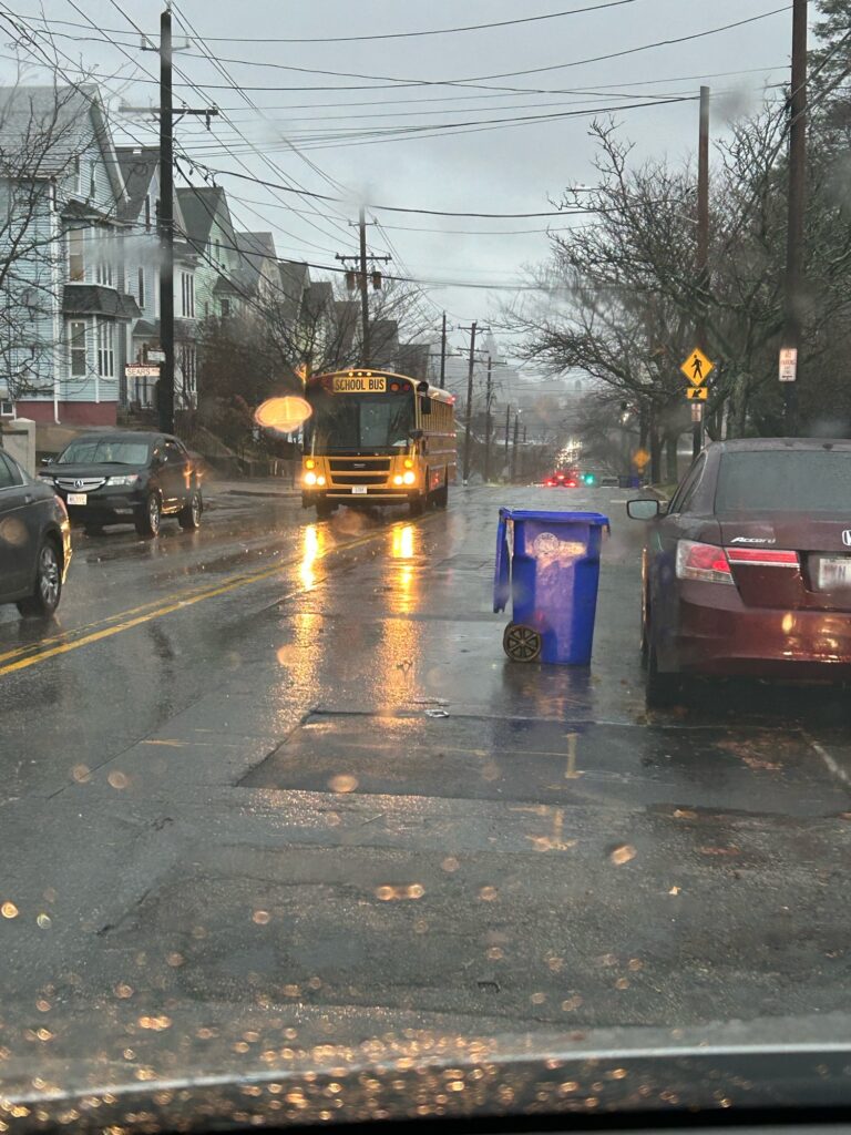 a yellow bus driving down a street (MyCoast AI)