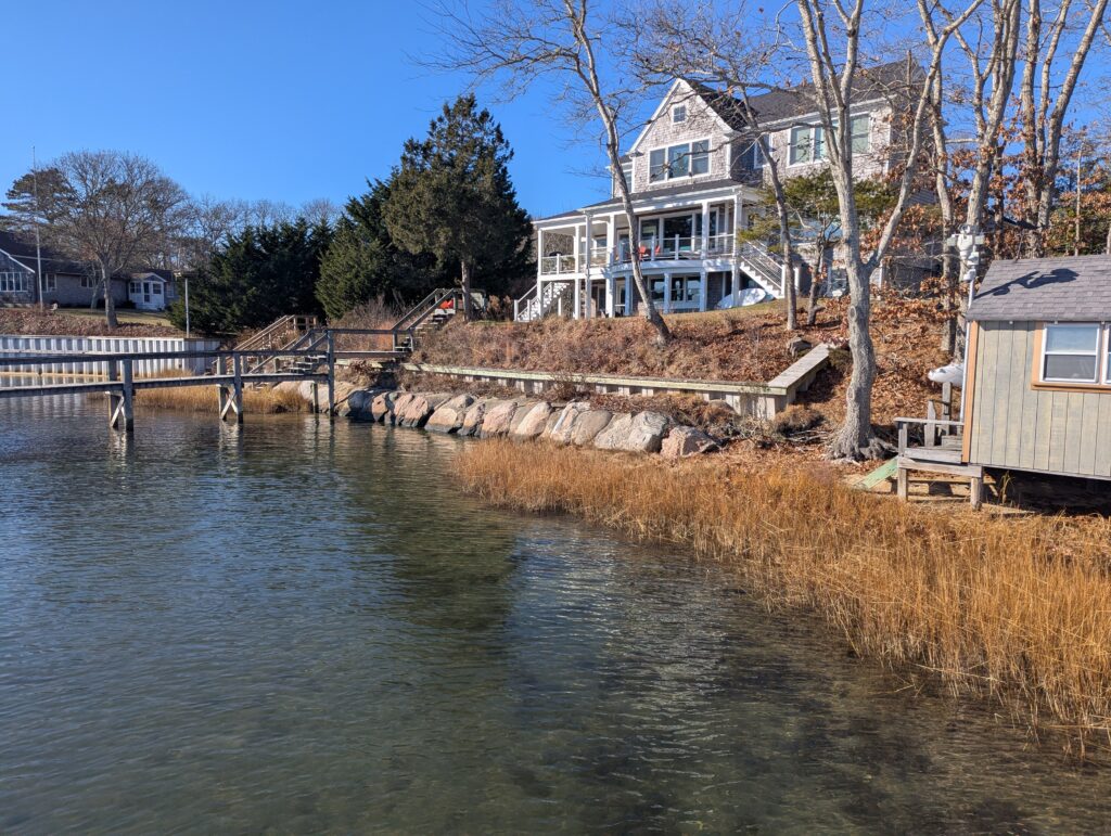 a river with a house in the background (MyCoast AI)