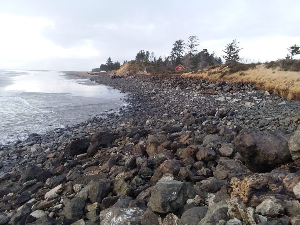 a rocky beach with a red tent (MyCoast AI)
